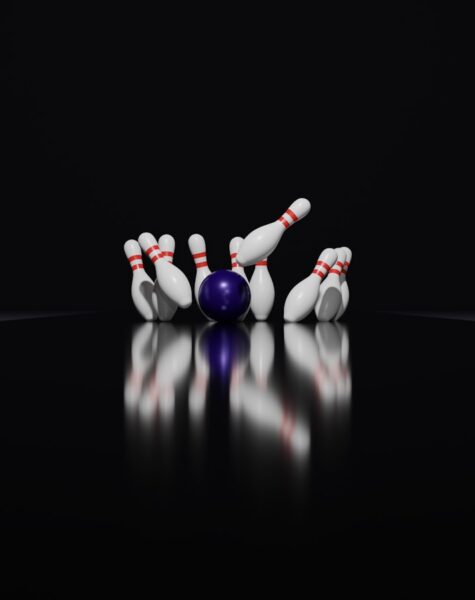 a bowling ball crashing into the pins of a bowling ball
